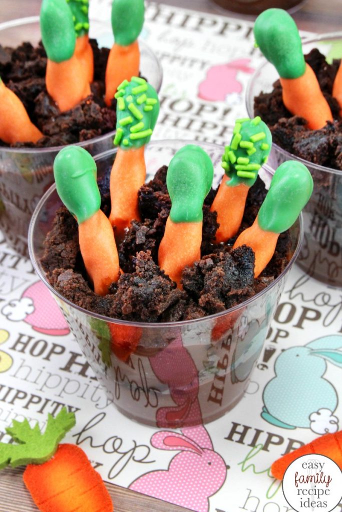 Easter Pudding Cups are so easy to make and the kids love them! These tasty carrot patch pudding snacks are so much fun to eat! Plus, the crunch of the pretzel and smoothness of the chocolate pudding makes them the perfect treat. Dirt Pudding Cups Recipe,carrot patch dirt cups, Easter dirt pudding cups