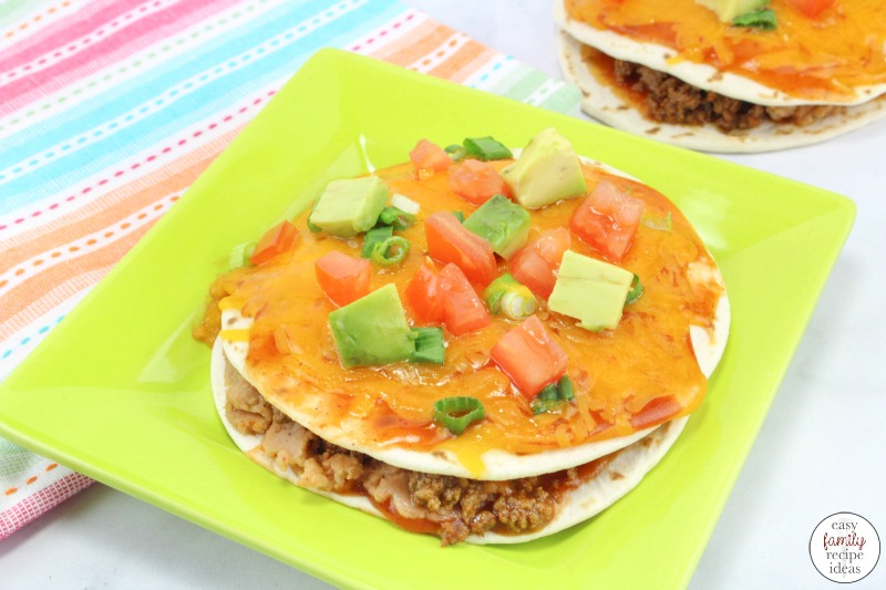 Taco Pizza Recipe, Mexican Pizza Stacks, Stacked Tortilla Taco Pizzas are baked in the oven covered with lots of delicious melted cheese and they taste amazing. Serve this yummy taco pizza with your favorite Taco Stuffings for a delicious Mexican pizza. 