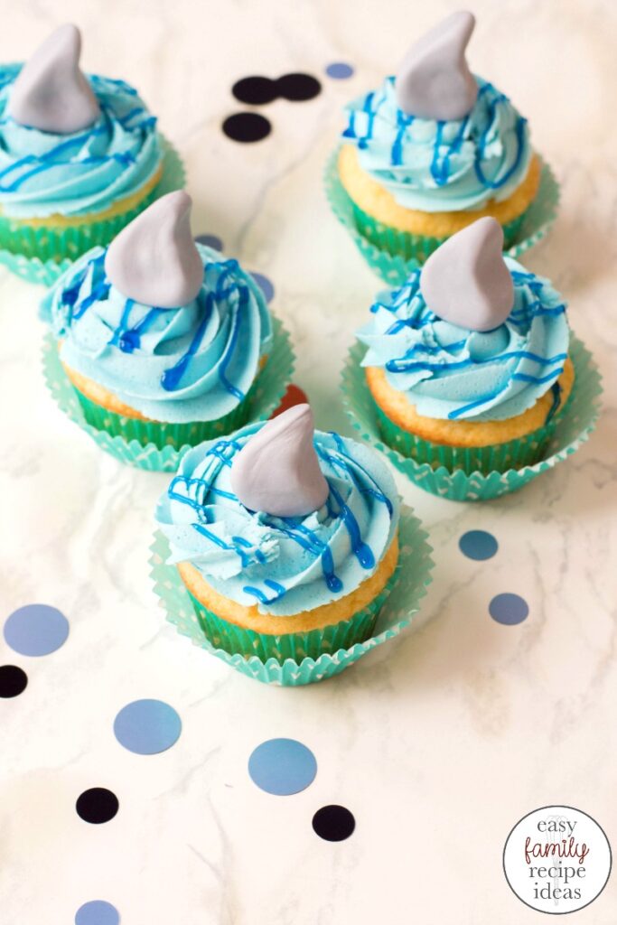 These shark cupcakes are tasty treats everyone will want to take a bite of. Learn how to make shark week cupcakes with this easy recipe and tips for the best ocean theme dessert. These Baby Shark Cupcakes are delicious and fun!
