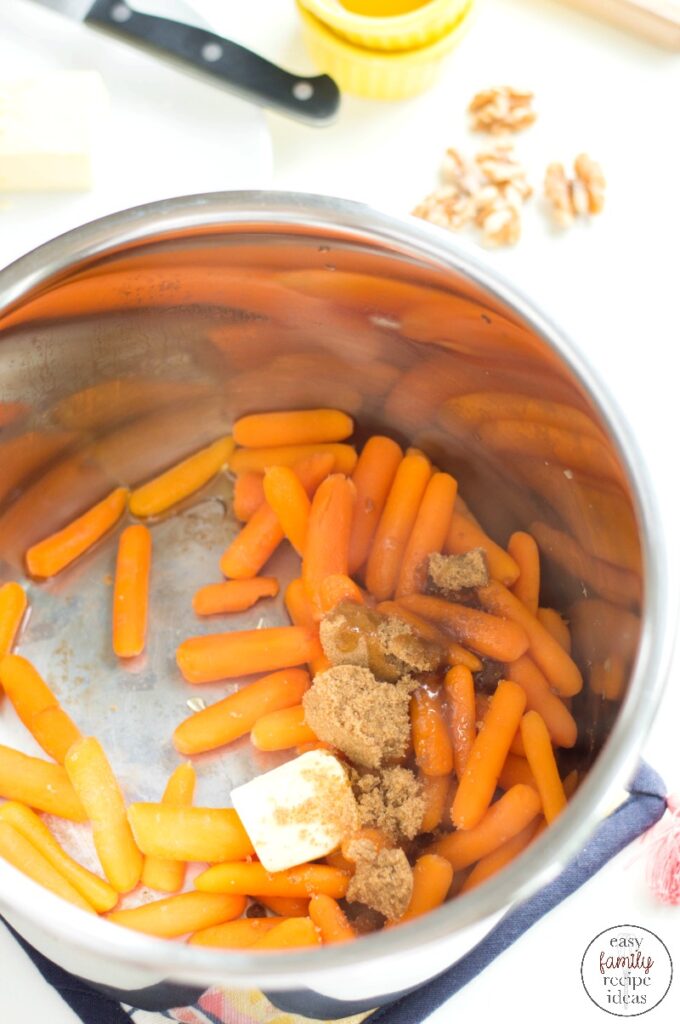 These Instant Pot Baby Carrots are the easiest side dish, ever! Perfect for a weeknight dinner or as a delicious holiday recipe. Easy Glazed Baby Carrots for a Thanksgiving Side Dish or Serve these up for your Christmas Dinner or any Easy Family Recipe.  