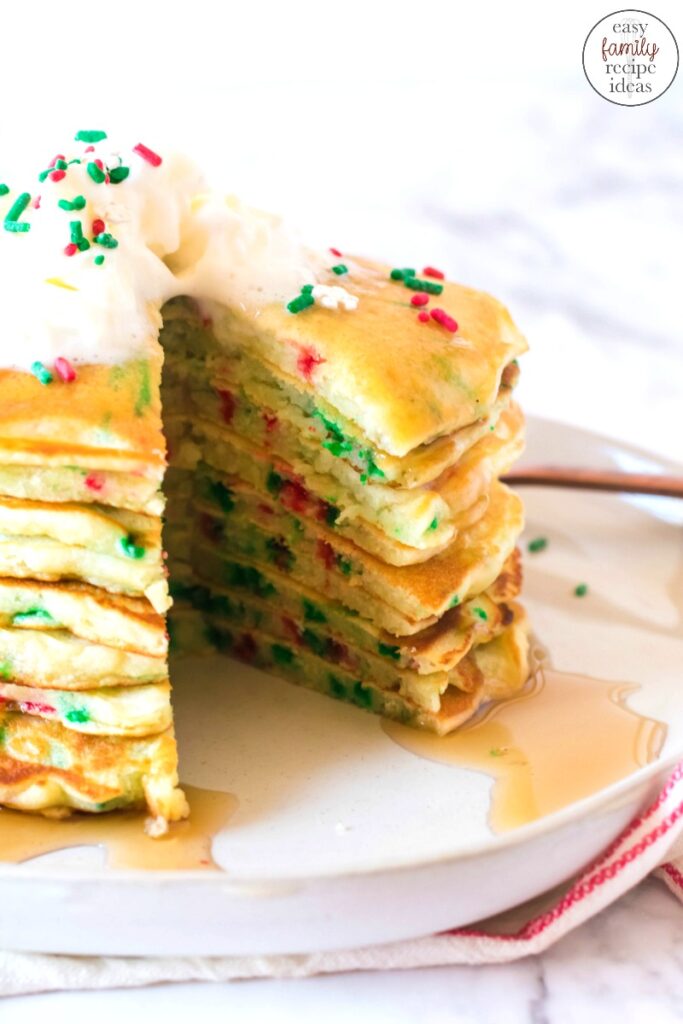 These Funfetti Christmas Pancakes are delicious and festive. Full of scrumptious flavor, color and holiday spirit, one stack of these homemade Christmas pancakes are perfect! Christmas Funfetti Pancakes, Get baking this holiday season with Elf Pancakes 