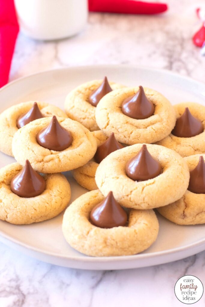 These Thumbprint Hershey Kiss Cookies are a must for the holiday season. The combination of peanut butter and chocolate is amazing! Plus everyone will love these Elf Poop Cookies for a sweet Christmas Cookie idea, Hershey kiss cookies, Peanut Butter Blossom Cookies are Delicious Any time during the year so add this easy peanut butter kiss cookies recipe to your list. 