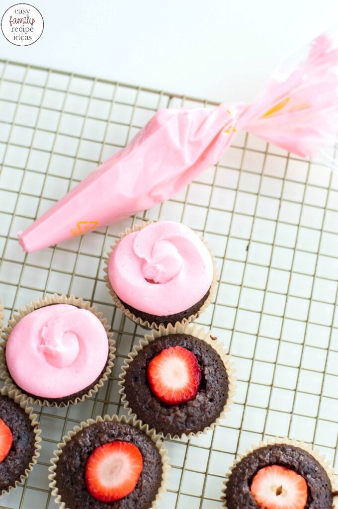These Chocolate Covered Strawberry Cupcakes are perfect for Valentine's Day! You get delicious kicked up boxed cake mix Cupcakes with Valentines Day Chocolate Covered Strawberries with great flavor in every bite! Chocolate cupcake with strawberry inside you have to try. The Perfect Valentine's Day Cupcakes