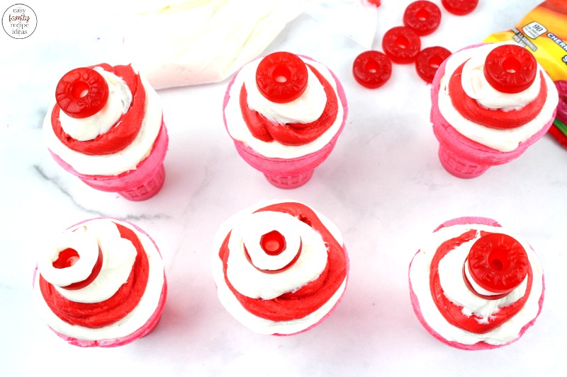 These Cat in the Hat Cupcakes are simple and fun to decorate together as a family! Read Dr Seuss books and enjoy tasty Dr Seuss Cupcakes for a treat. Perfect for Dr Seuss Food Ideas or Dr Seuss Party Food, These Dr Seuss Cat in the Hat Cupcakes are delicious, Ice Cream Cone Cupcakes for the win!