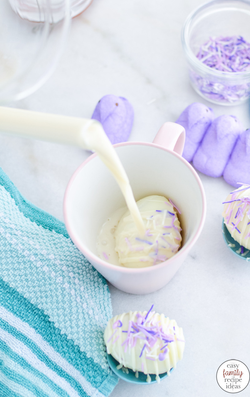 Simply place the delicious white hot chocolate Easter egg in a mug and pour hot milk over it. They'll burst open to let the marshmallow peep out for a tasty Easter treat. Easter Egg Peeps White Hot Chocolate Bombs for the win this holiday. 