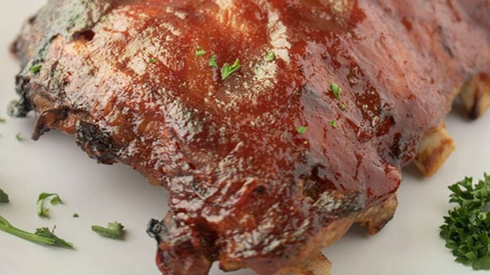 Bbq ribs on a white plate.