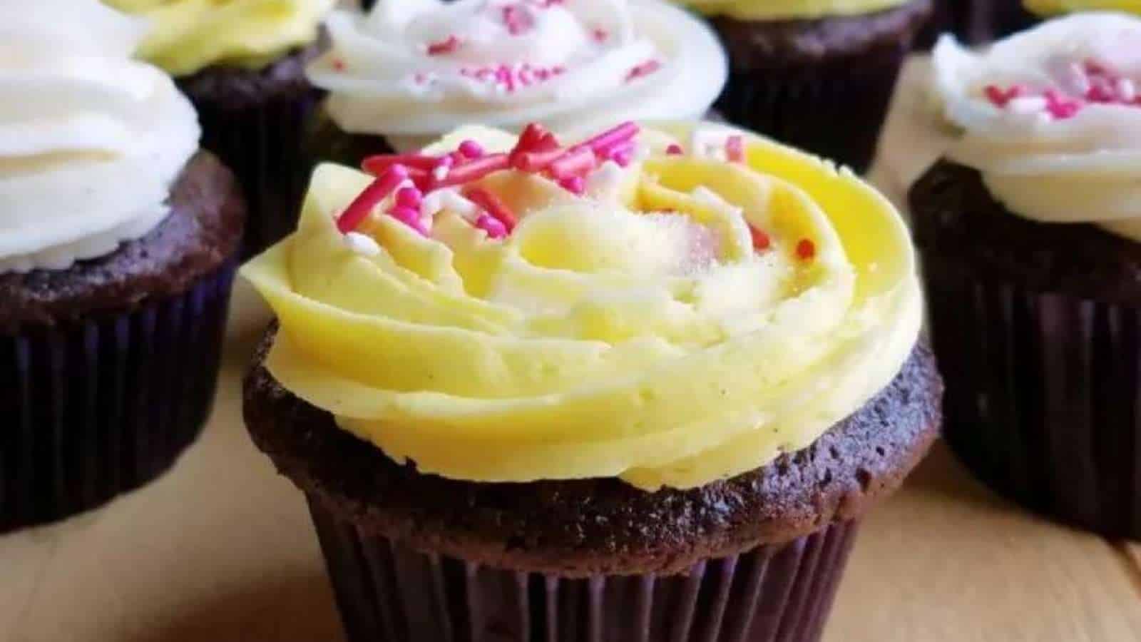 A group of cupcakes with yellow and white frosting.