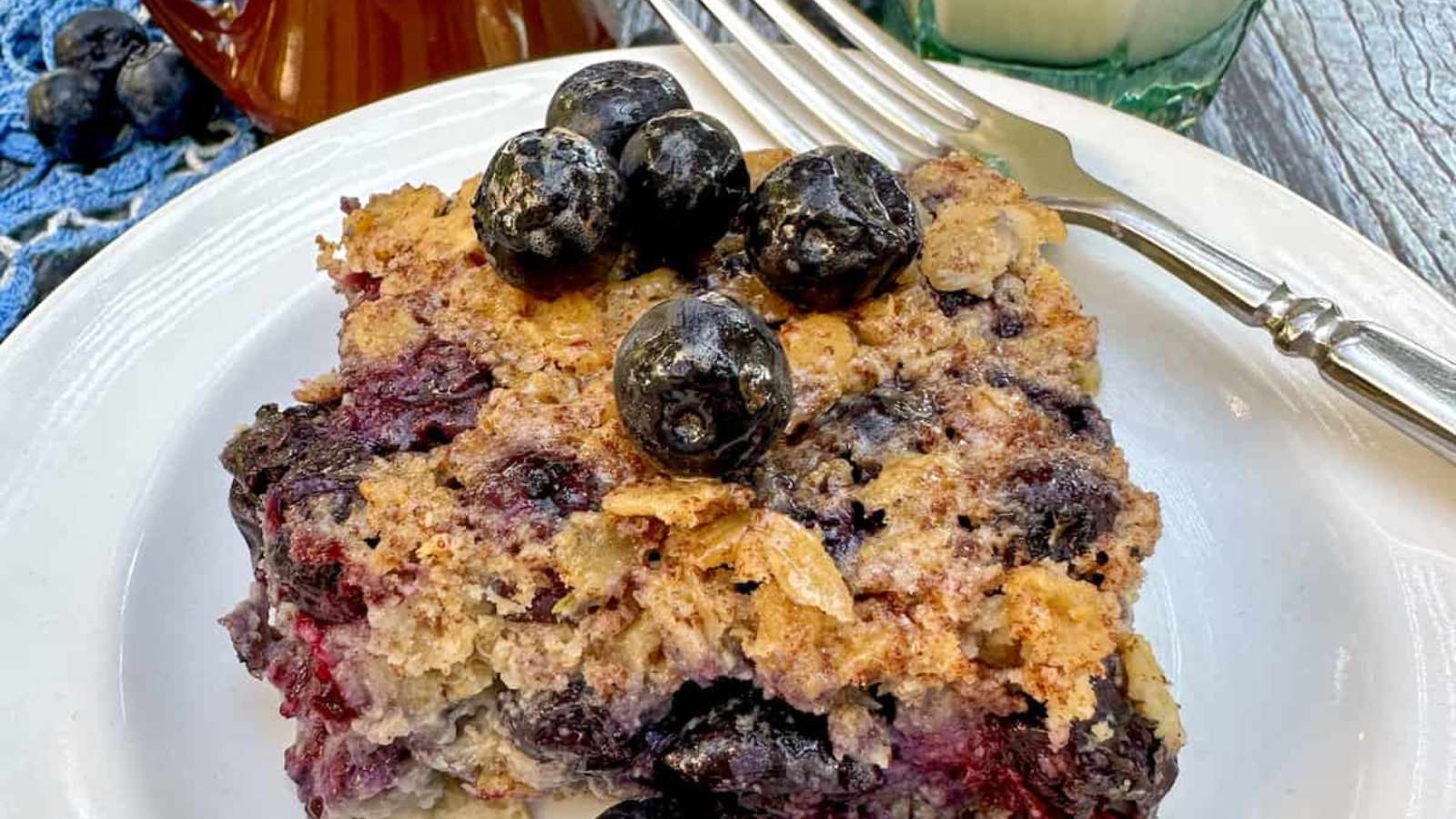 Blueberry coffee cake on a plate with a fork.