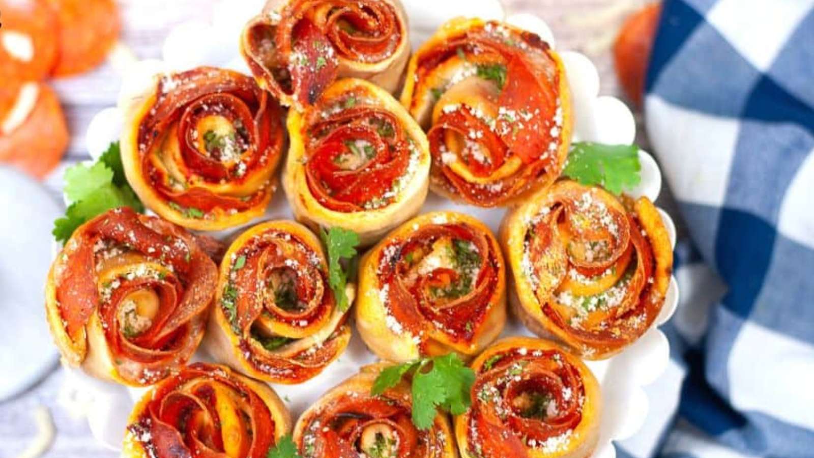 A plate full of pizza pinwheels on a table.