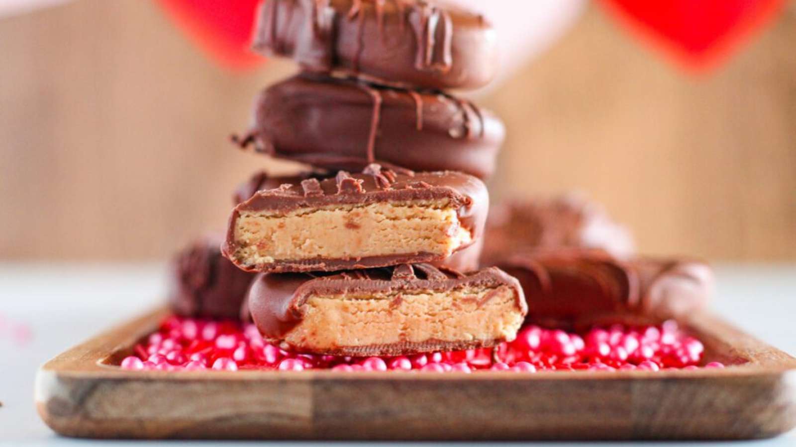 A stack of chocolate peanut butter on a wooden tray.