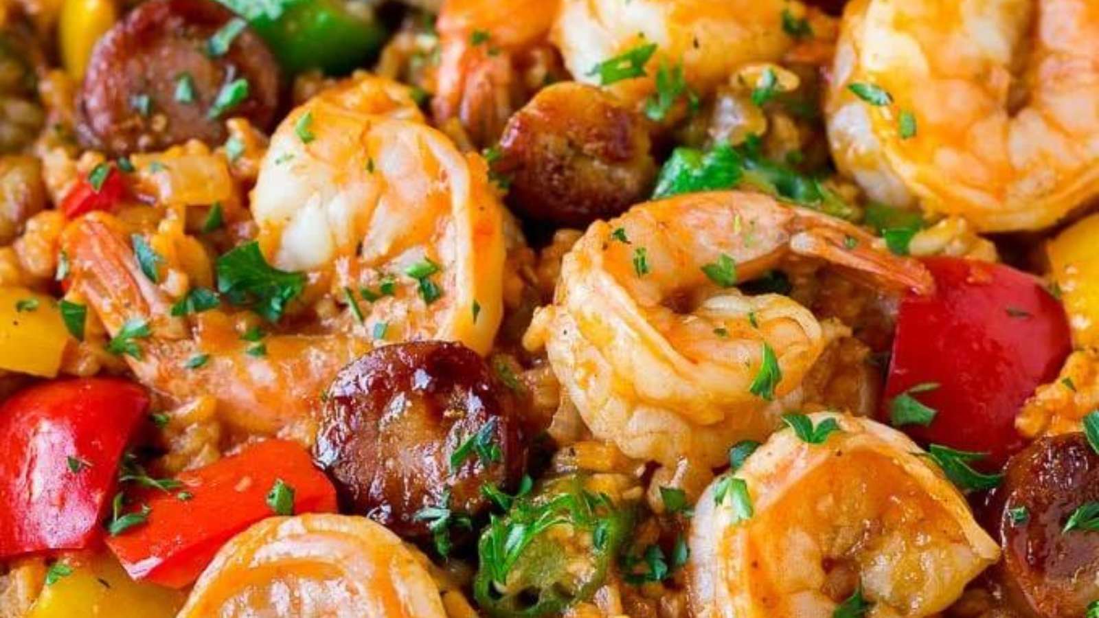 A dish with shrimp, peppers and rice.
