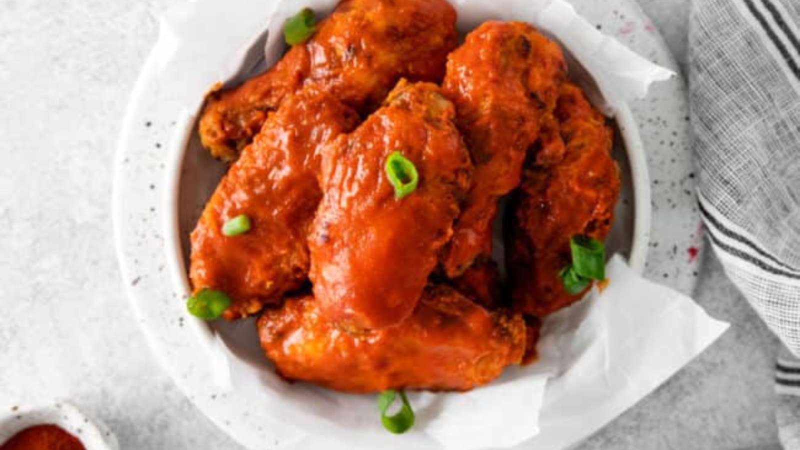 Buffalo chicken wings on a white plate.