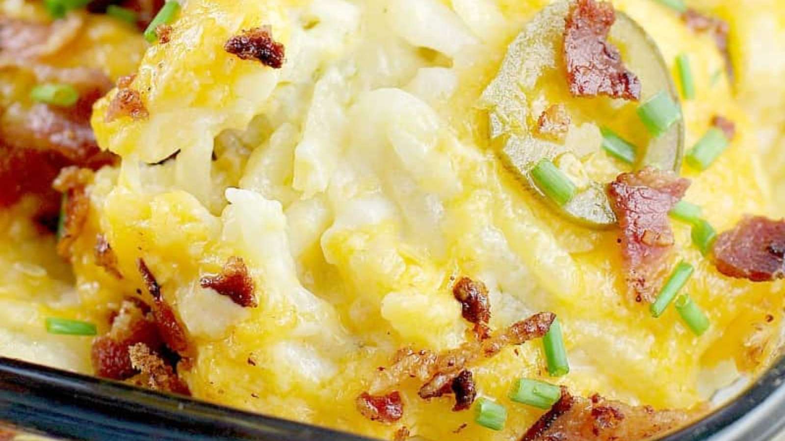 A casserole dish with bacon and cheese on top.