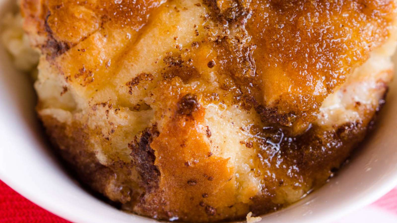 A close up of a bread pudding in a white bowl.