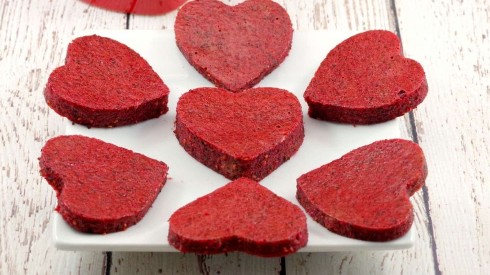 Heart shaped red beets on a white plate.