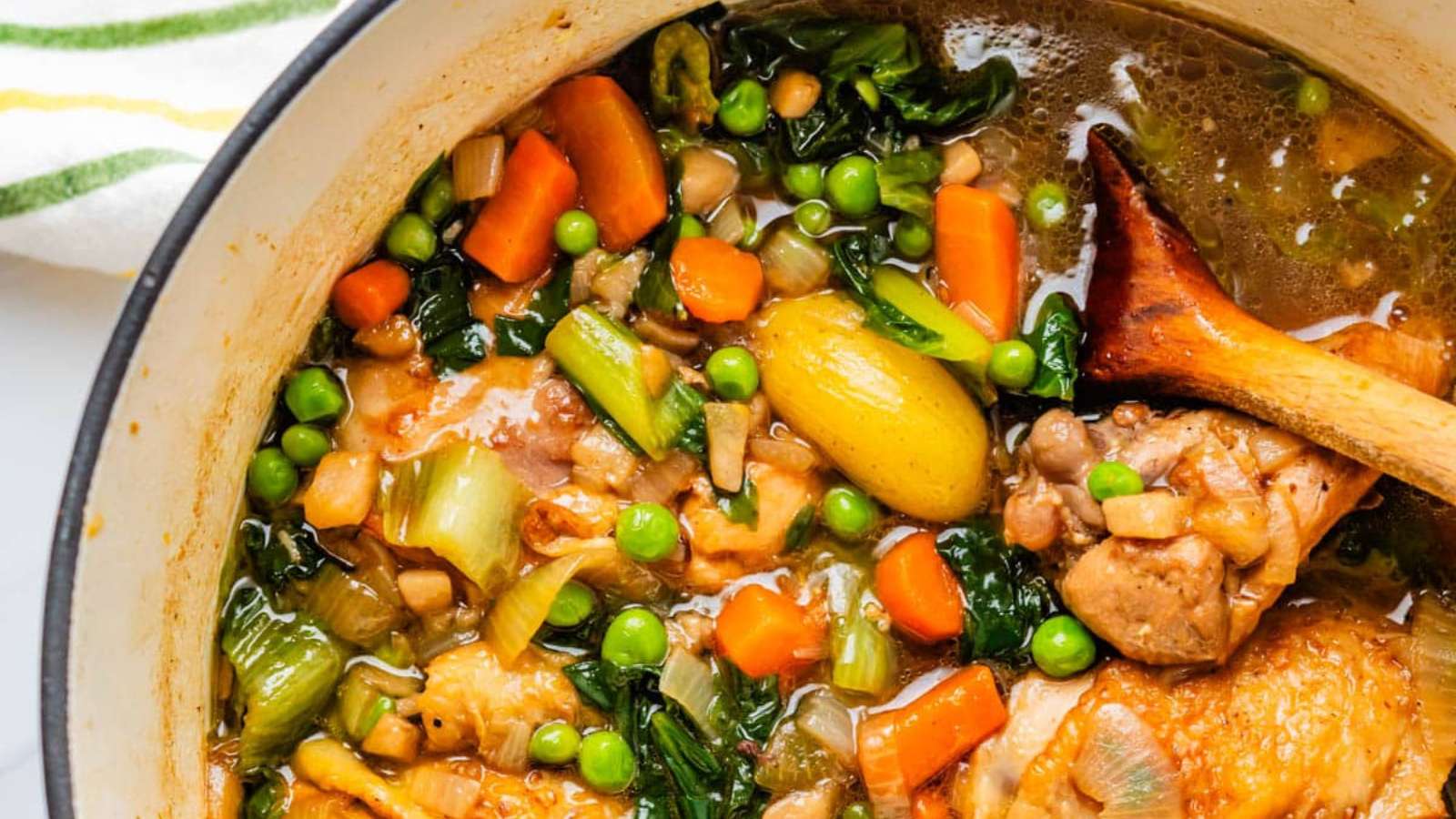 A hearty pot of chicken soup with flavorful vegetables.