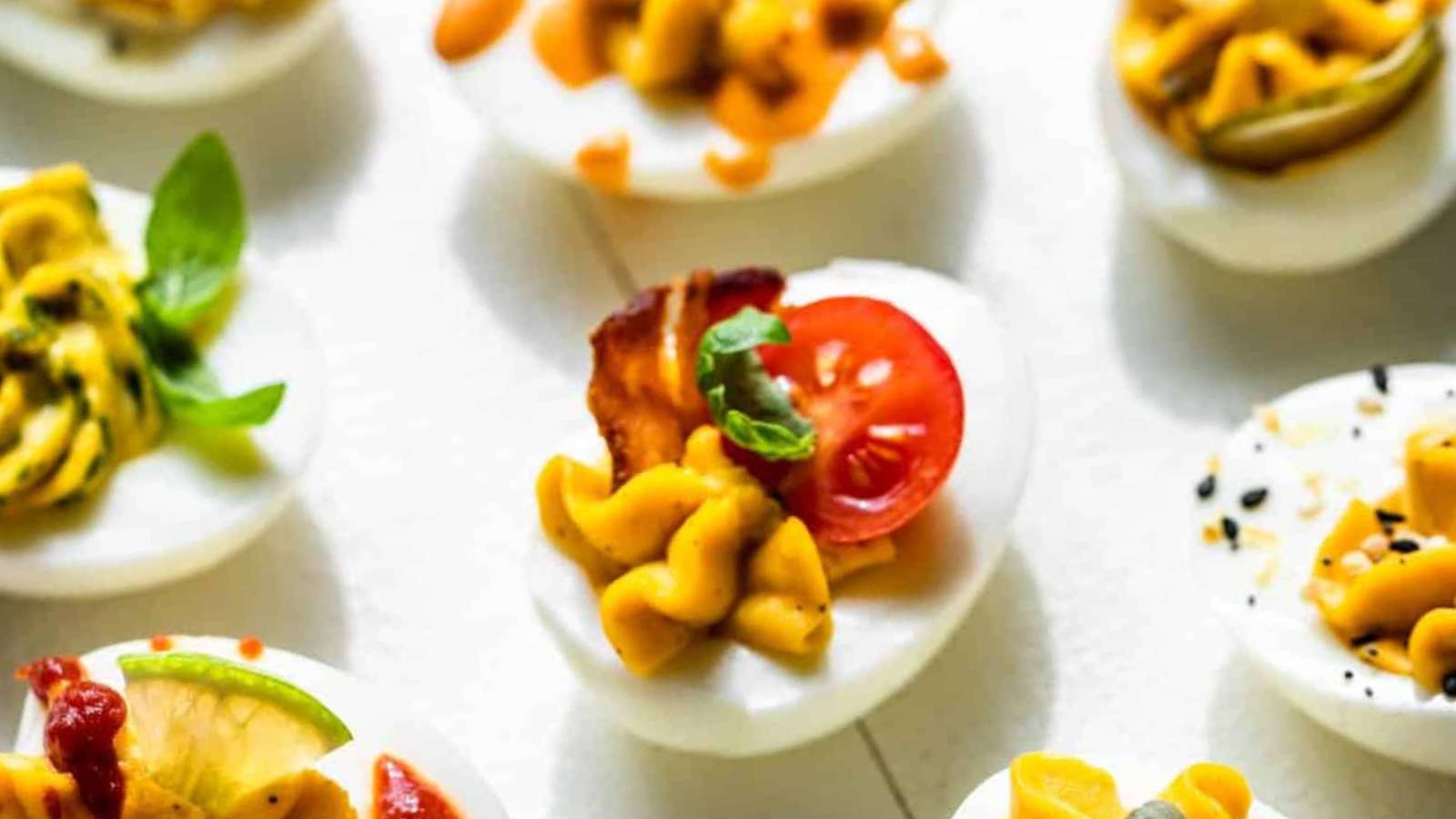 Deviled eggs with a variety of toppings.