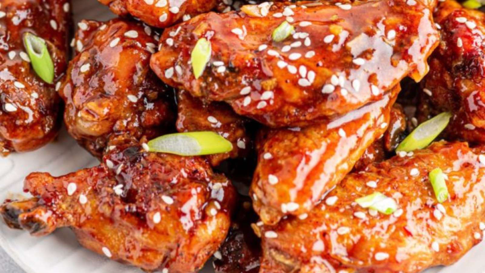 Sweet Chili chicken wings on a plate with sesame seeds.
