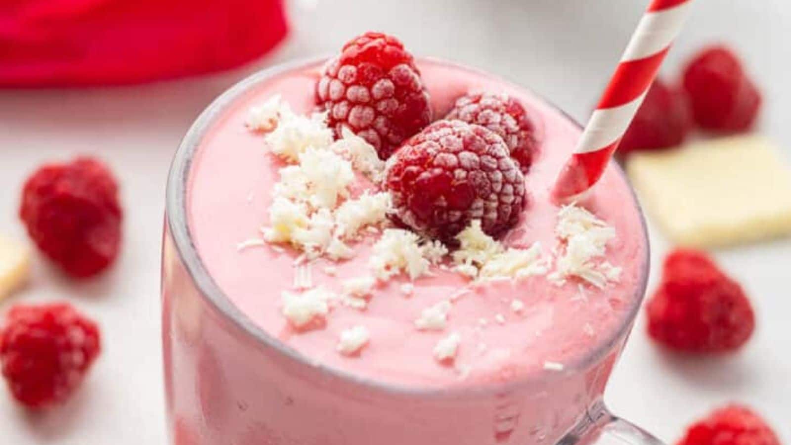 A pink smoothie with raspberries and white chocolate.