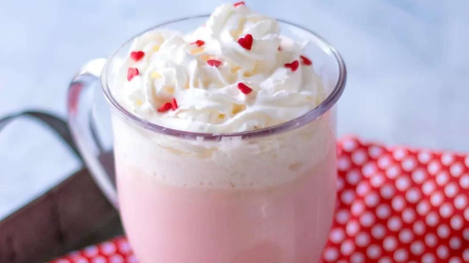 Pink hot chocolate with whipped cream.