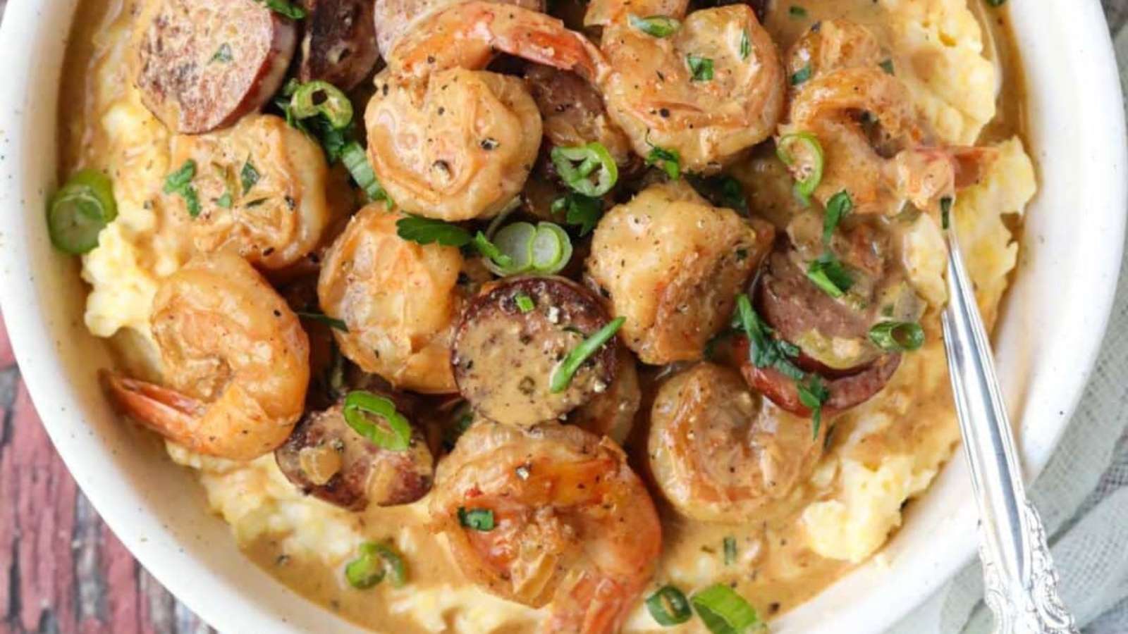 Shrimp and grits in a white bowl.
