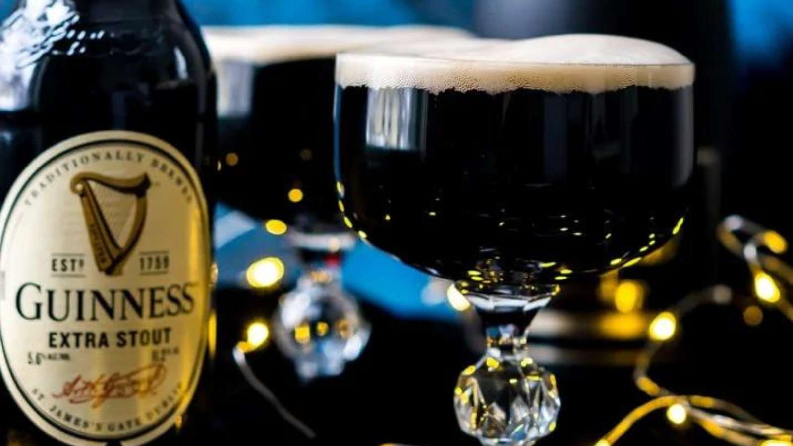 A recipe made with guinness beer - two glasses and a bottle of beer.