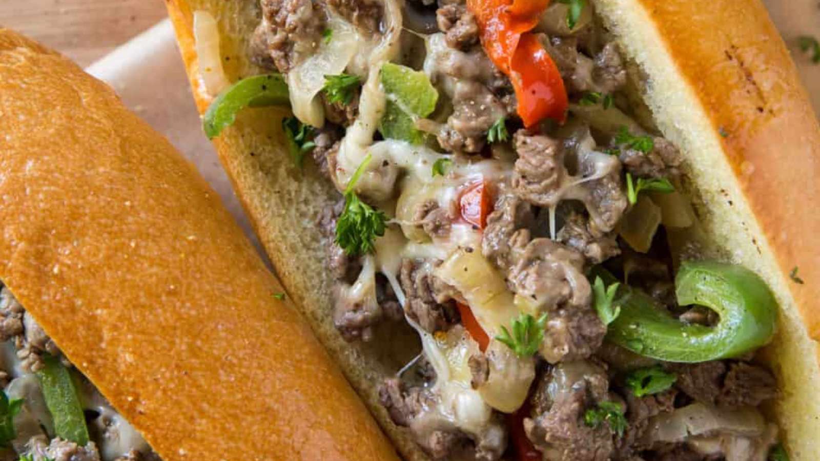 A philly cheesesteak sandwich with peppers and cheese.