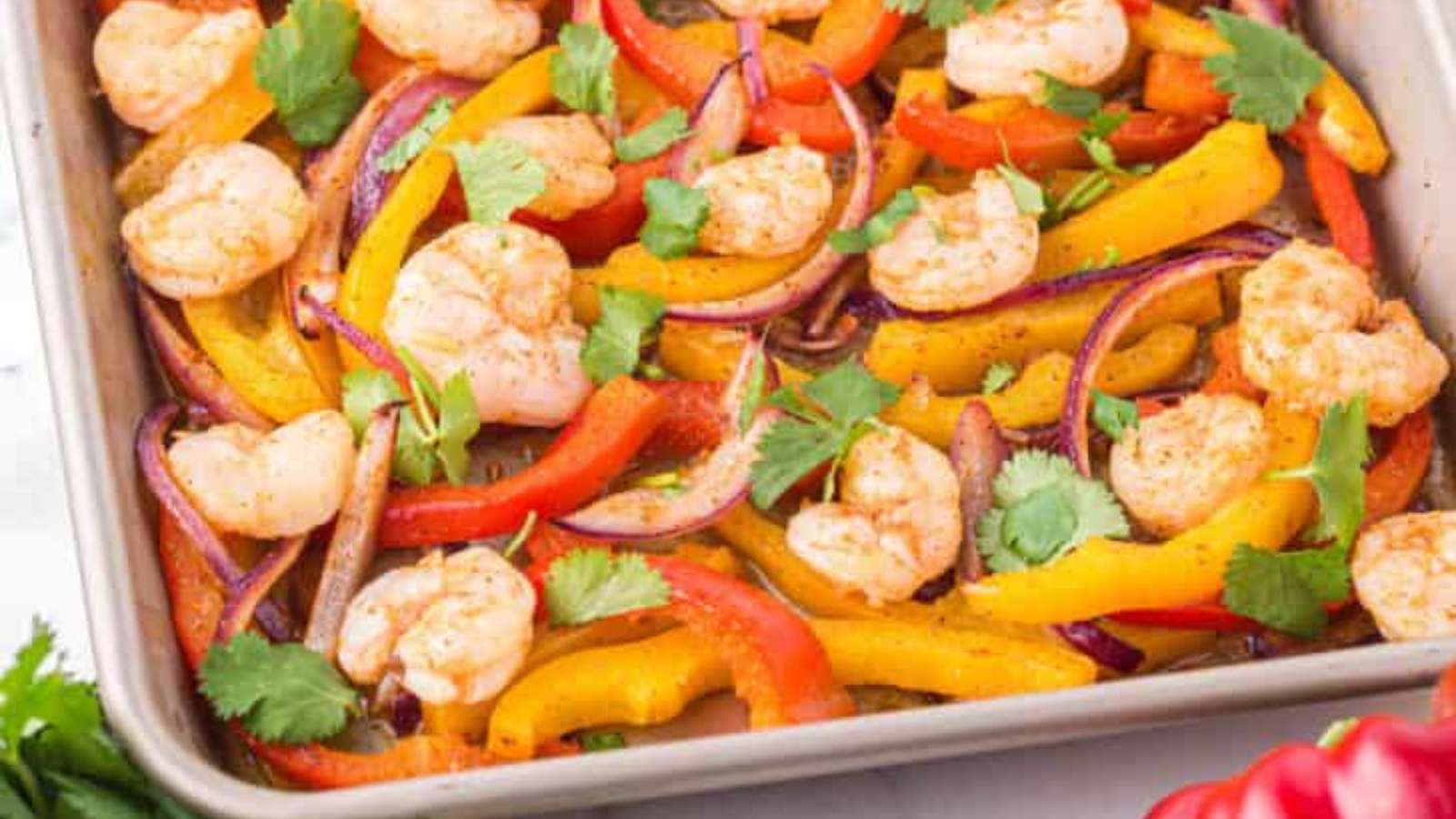Shrimp and peppers in a baking dish.
