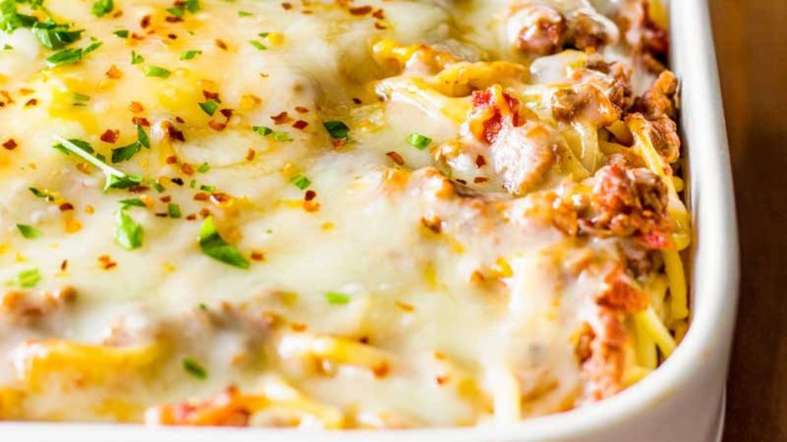 A casserole dish with meat and cheese on top.