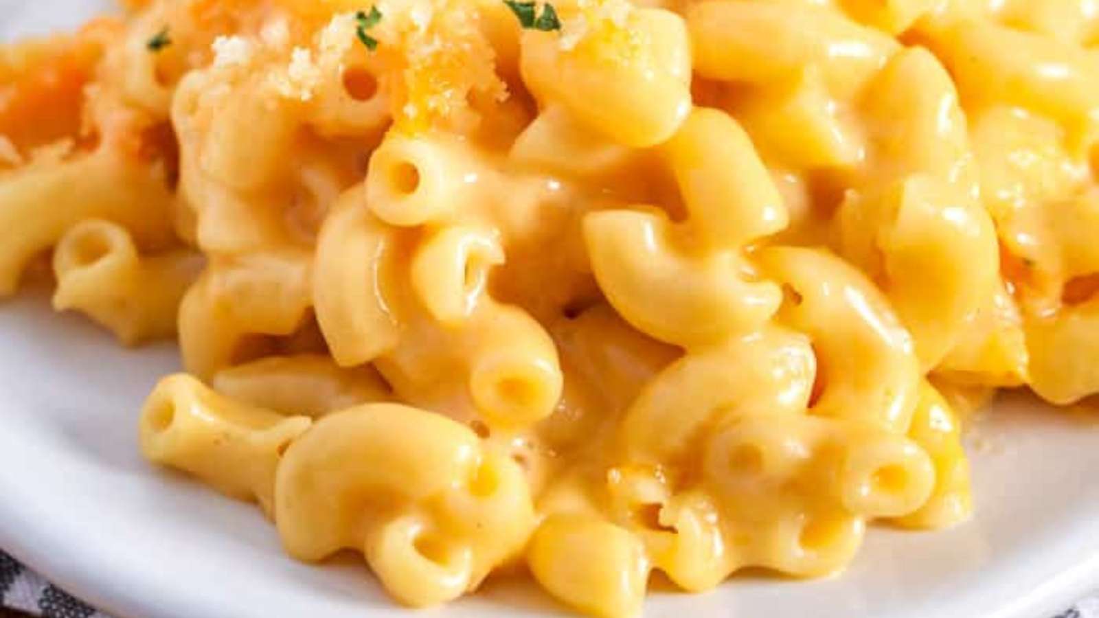 A plate of macaroni and cheese on a white plate.