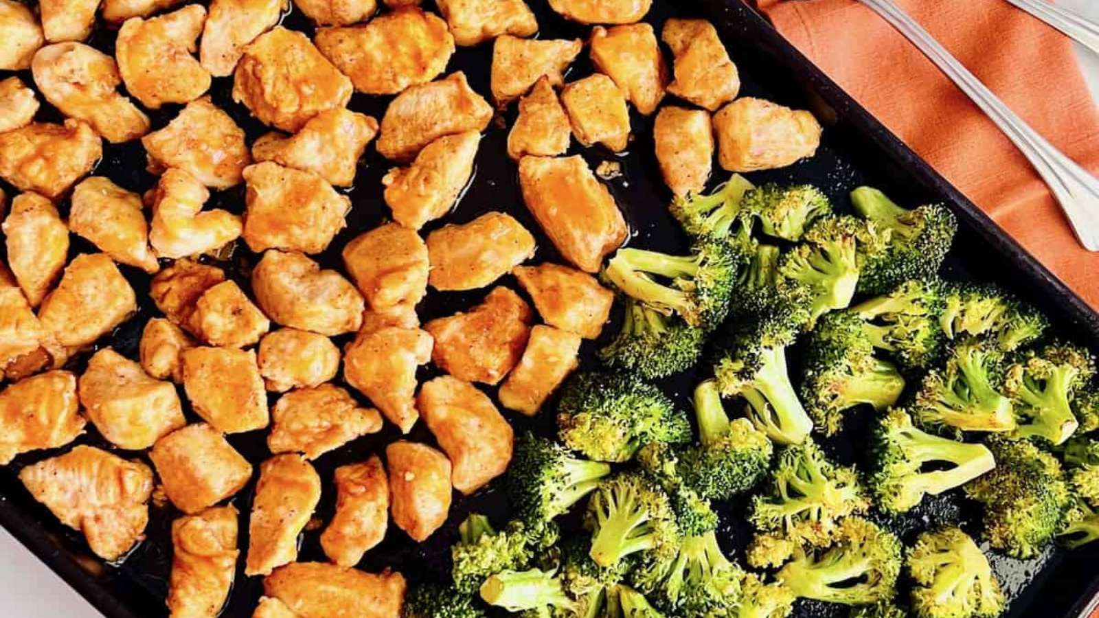 Chicken and broccoli on a baking sheet.